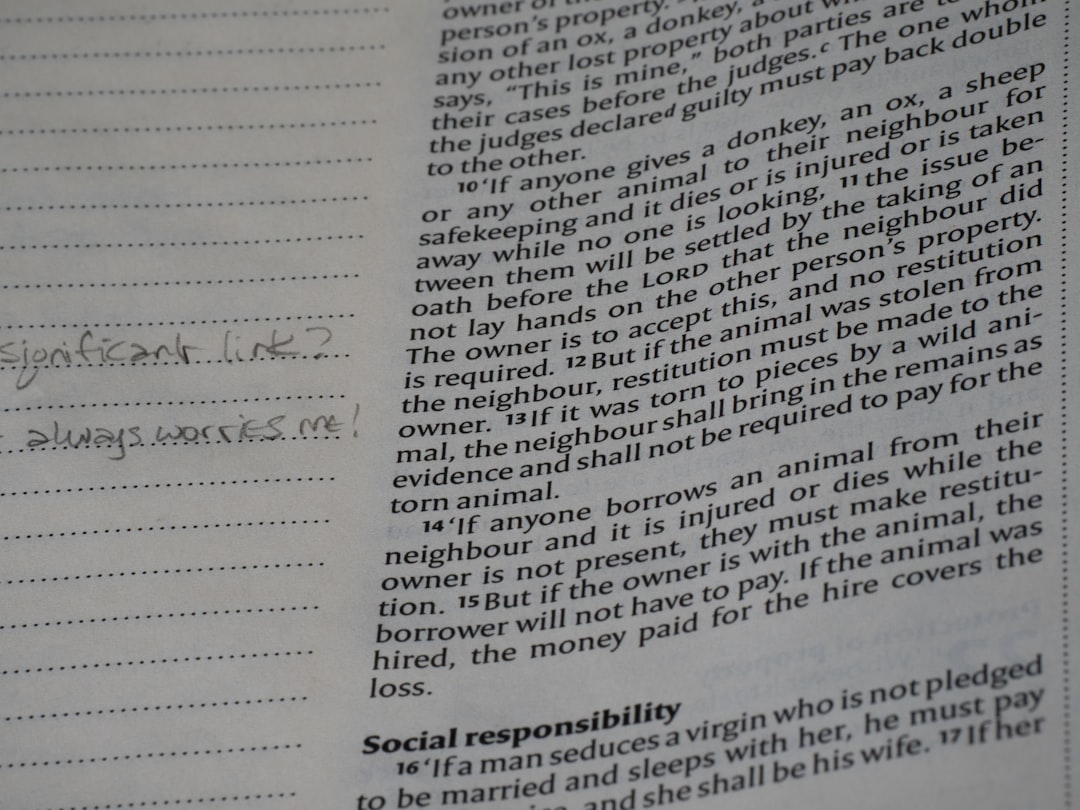 Close-up of a page from a book with handwritten notes.